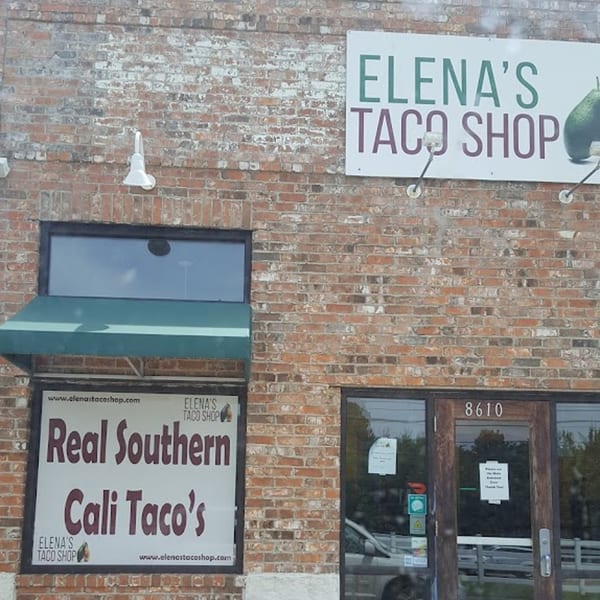 Exterior of Elena's Taco Shop, a brick building with signs for "Real Southern Cali Taco's" and the shop's name.