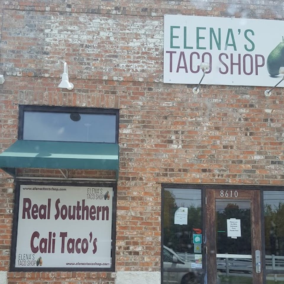 Exterior of Elena's Taco Shop, a brick building with signs for "Real Southern Cali Taco's" and the shop's name.